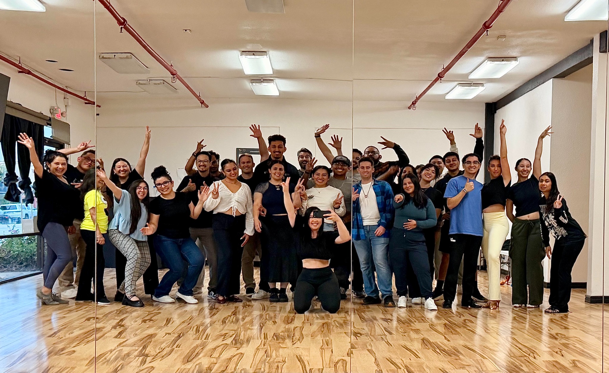 Vida Dance Co. community posing together in the studio
