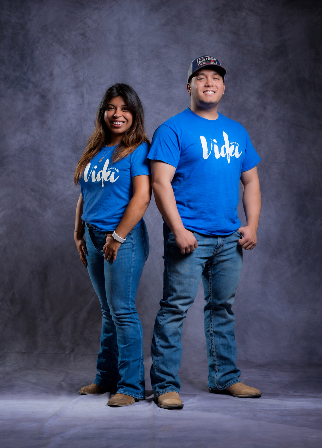 Two Vida Dance Co. line dancers in blue studio shirts