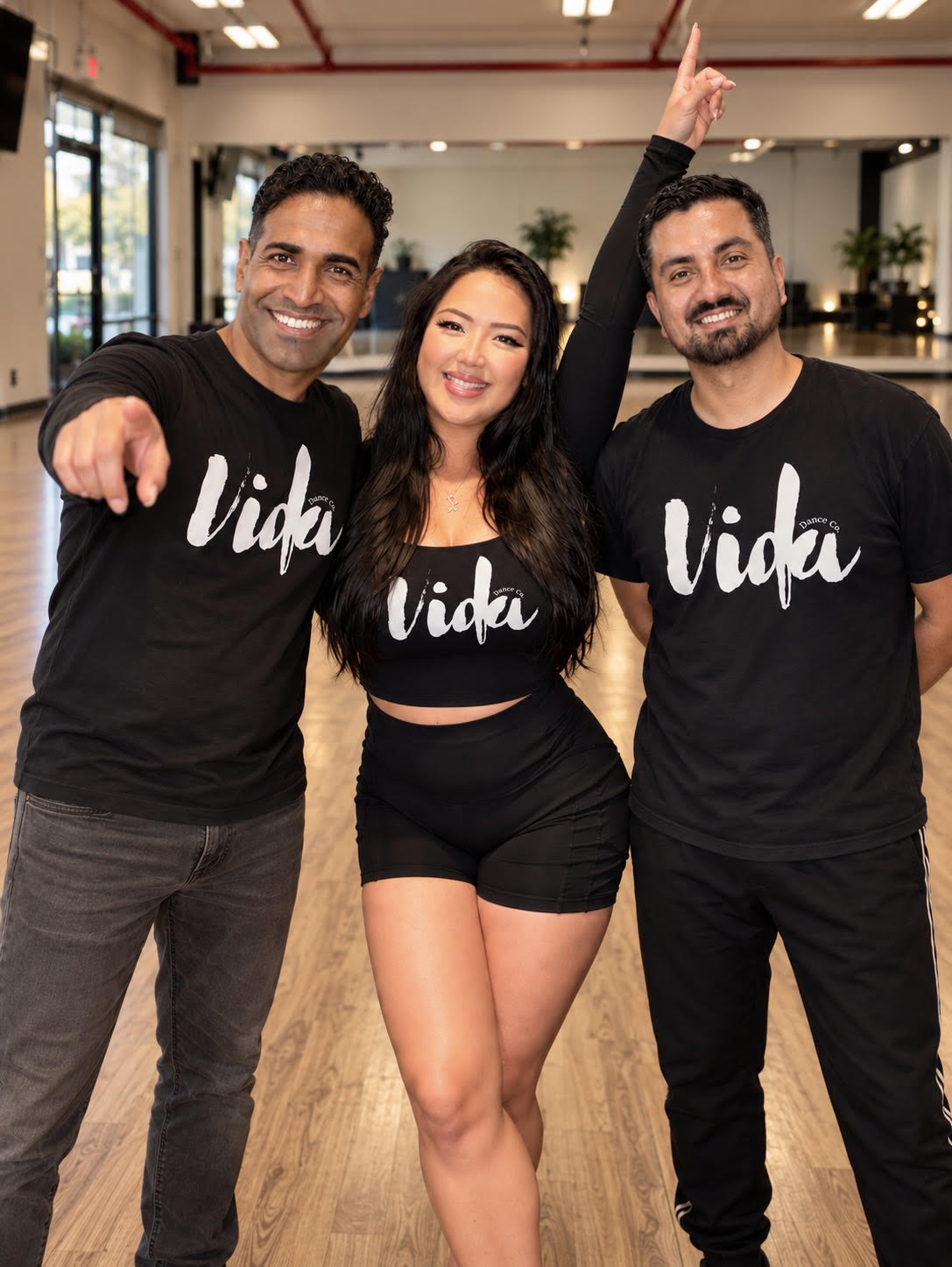 Three Vida Dance Co. dancers in black studio shirts